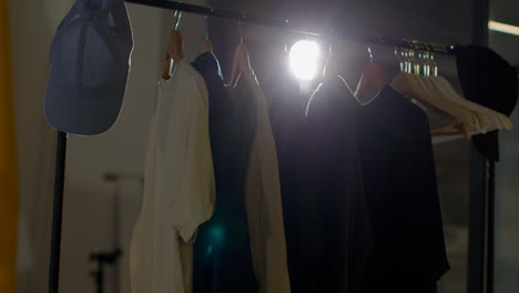 Close-Up-Of-Wardrobe-Clothing-Hanging-On-Rail-During-Movie-Or-Video-Shoot-In-Film-Studio